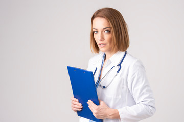 Attractive middle aged female doctor portrait at isolated white background