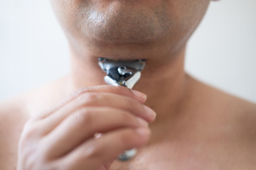 Fototapeta premium Man shaves a shaving machine without using foam