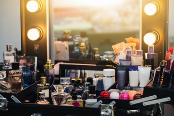 Mirror with round lamps. Cosmetics for makeup women. Dressing table with a mirror. 