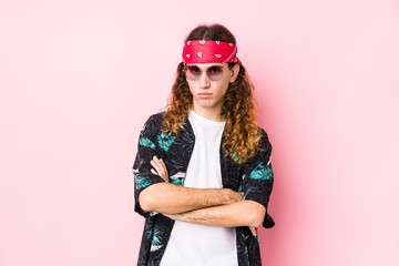 Young hippie caucasian man isolated unhappy looking in camera with sarcastic expression.