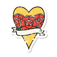 traditional distressed sticker tattoo of a heart and banner with flowers