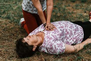 Young woman offering medical support to an elder