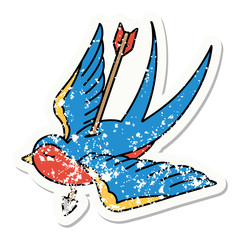 traditional distressed sticker tattoo of a swallow shot through with arrow