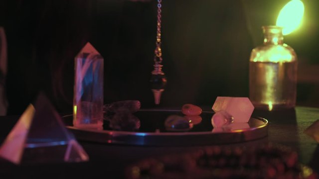 Medium close up of fortune spelling on pendulum 