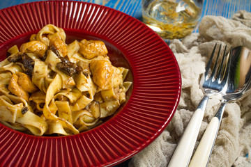 Tagliatelle pasta with chicken and boletus mushrooms.