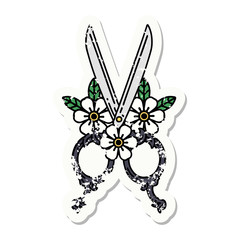 traditional distressed sticker tattoo of a barber scissors and flowers