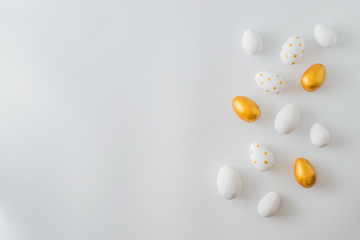Flat lay pattern with a easter eggs on a white background