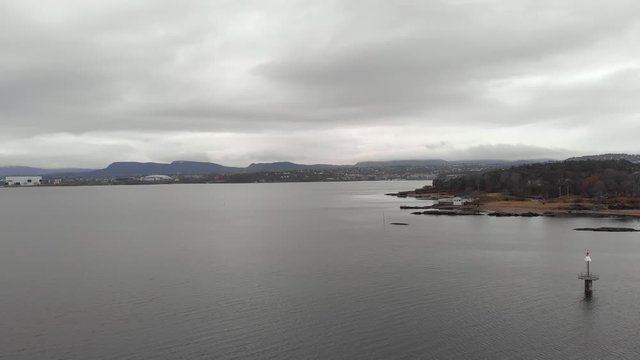 Bygd&oslash;y Beach on Oslo city coastline on overcast day, aerial dolly view