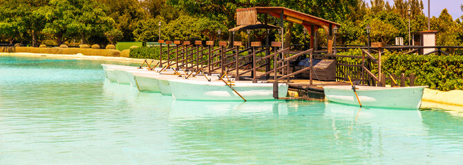 A beautiful place in a city park with water and moored white boats, a perfect place for a romantic time for couples and honeymooners