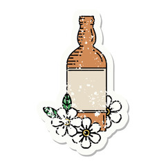 traditional distressed sticker tattoo of a rum bottle and flowers