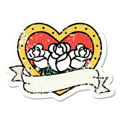 traditional distressed sticker tattoo of a heart and banner with flowers