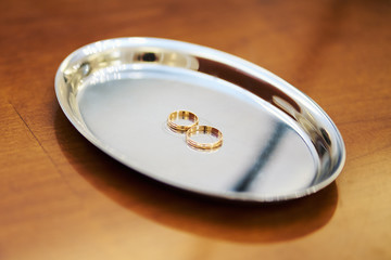 two beautiful gold wedding rings on a tray