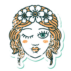 distressed sticker tattoo style icon of a maidens face winking