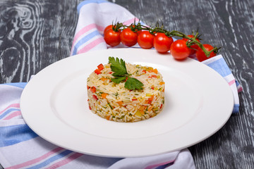 Hawaiian rice with red and yellow sweet peppers and herbs in restaurant serving
