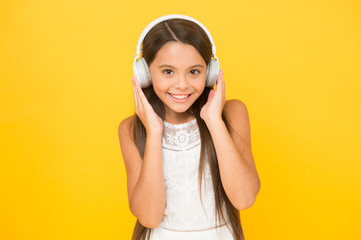 listening to music. little girl with headphones. she is happy with the music. Modern technologies...
