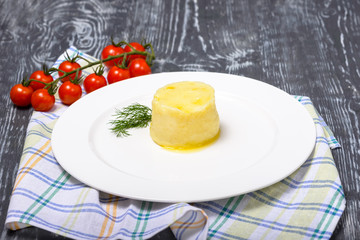mashed potatoes with butter and cheese and herbs in restaurant serving