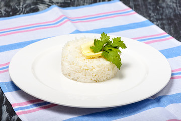 Garnish of boiled long-grain rice with butter in round form. Restaurant serving