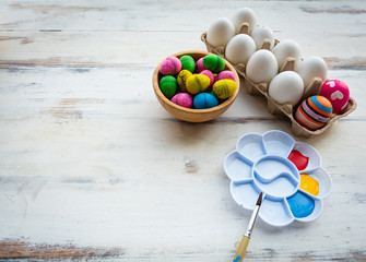 Eggs and coloring tools are prepared on the table