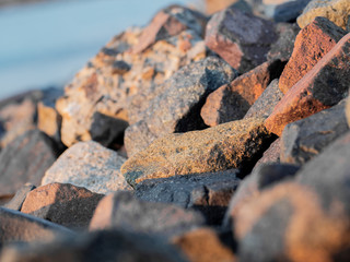 stones on the shore closeup. Stock photo. Beautiful rocks on the Sunset. Background bright colors