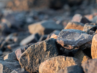 stones on the shore closeup. Stock photo. Beautiful rocks on the Sunset. Background bright colors