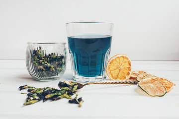 Butterfly pea flower blue tea. Detox drinking on dark table. Healthy herbal drink. Blue herbal tea anchan with lime