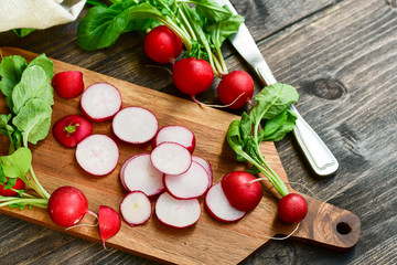 radish vitamin salad, sliced fresh radish on wooden Board. salad recipe with seasonal vegetables, healthy diet food. selective focus