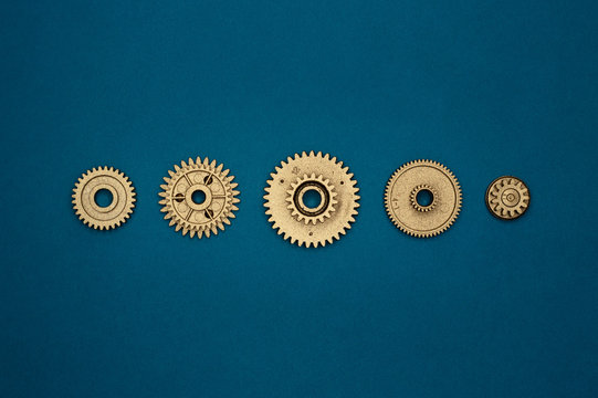 template of five golden gears on blue background