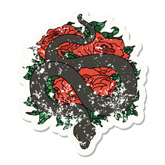 traditional distressed sticker tattoo of a snake and roses