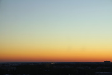 Flaming sky over the horizon during sunset or sunrise. Bright iridescent colors of yellow, orange and red. Colored background for text and design