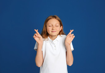 Portrait of emotional preteen girl on blue background