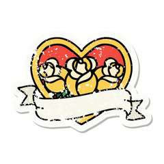 traditional distressed sticker tattoo of a heart and banner with flowers