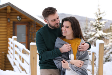 Fototapeta premium Lovely couple spending time together on snowy day. Winter vacation