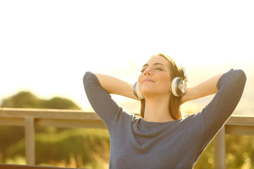 Relaxed woman listening to music in the nature