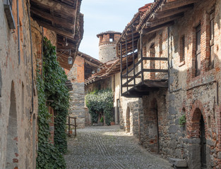 Ricetto di Candelo, old cobblestone street of the fortified medieval village. Piedmont - Italy - obrazy, fototapety, plakaty