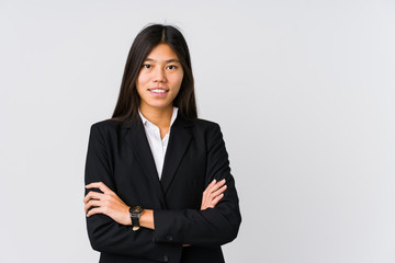 Young asian business woman smiling confident with crossed arms.