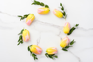 Flowers composition. Yellow and pink flowers on marble background. Spring, 8 of march, woman day, mothers day, easter concept. Flat lay, top view, copy space.