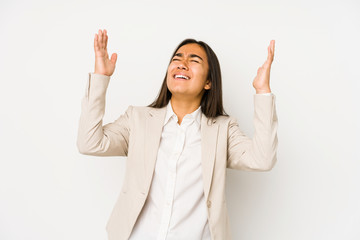 Young woman isolated on a white background screaming to the sky, looking up, frustrated.