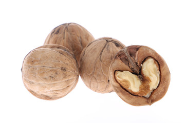 Whole and cracked walnuts isolated on white background