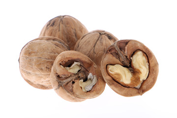 Whole and cracked walnuts isolated on white background