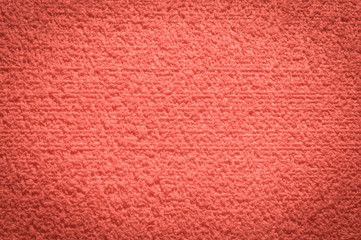 textured fabric trendy coral pink surface for background and wallpaper with dark vignetting gradient