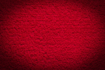 textured fabric trendy red surface for background and wallpaper with dark vignetting gradient