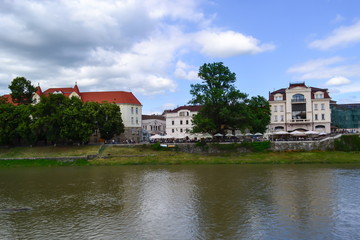 river and embankment, blue sky, white clouds, linden trees, Uzhhorod, Ukraine