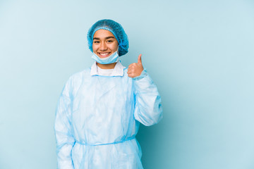 Young surgeon asian woman isolated smiling and raising thumb up