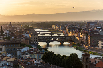 Fototapeta na wymiar The famous bridge Ponte Vecchio in Florence over the river Arno during sunset