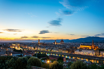Fototapeta na wymiar Panorama of Florence with Palazzo Vecchio and the cathedral Santa Maria del Fiore and Ponte Vecchio during sunset
