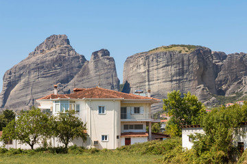 The Meteora - largest and most famous built complexes of Eastern Orthodox monasteries. Greek flag.