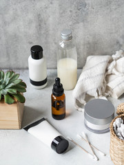 Set of female skin care products. Makeup products and skin cleansers on a gray background.