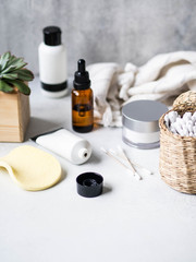 Set of female skin care products. Makeup products and skin cleansers on gray background. Copy space