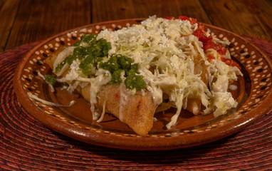 Fried style Quesadillas breaded with lettuce, cheese, green and red sauces, typical Mexican food 3.