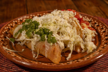Fried style Quesadillas breaded with lettuce, cheese, green and red sauces, typical Mexican food 4.